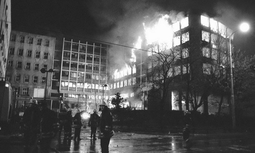 The RTS building in Belgrade, Serbia, burns after it was hit with a NATO missile on April 23, 1999, killing 16 inside. Photo via SerbiaSos.