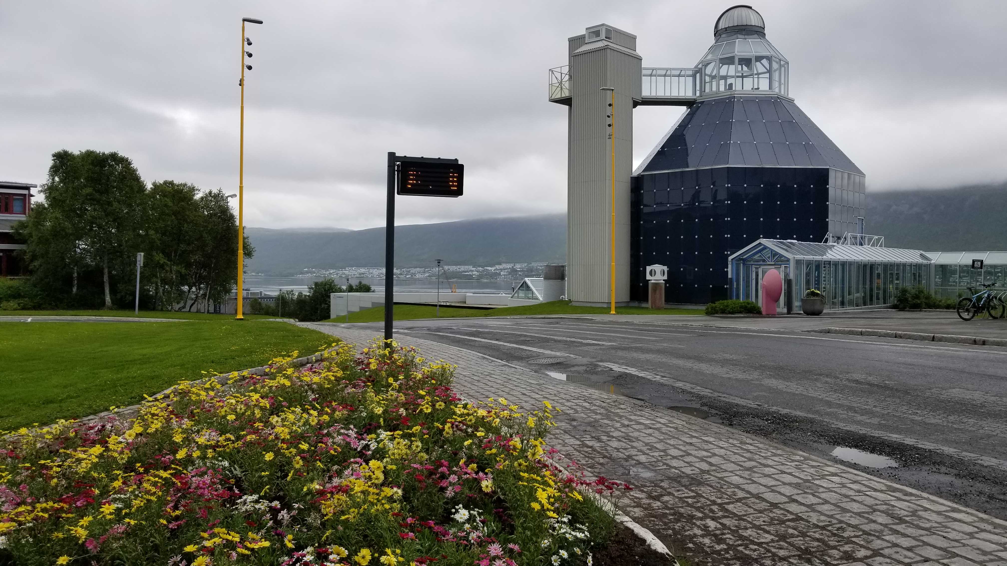 View of the planetarium, mountains, and harbor from the bus stop.